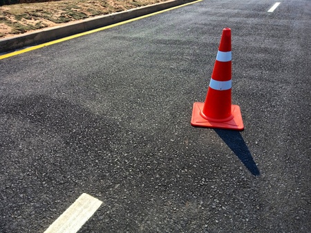Red rubber cone placed on the road to ensure safety