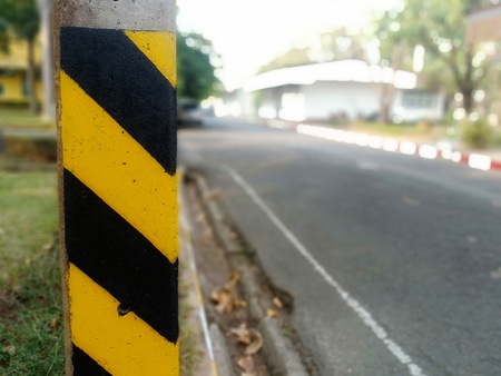 Electric poles beside the road Painted warning to prevent dangerの写真素材