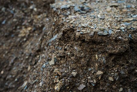 Stone mixed soil is used to repair damaged roads.の写真素材