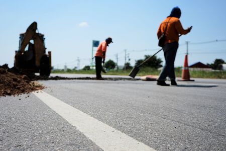 Heavy equipment is digging to repair the damaged road (blurred picture)