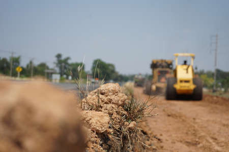 The image is blurred in the construction of asphalt road. With heavy machinery
