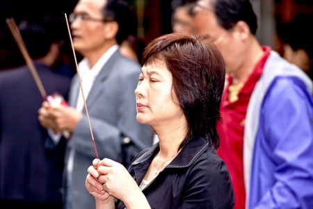 Taipei-May 24:closeup of a woman in prayer in chinese temple on May 24,2011 in Taiwanのeditorial素材