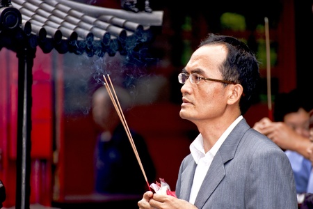 Taipei-May 24:closeup of a man in prayer in chinese temple on May 24,2011 in Taiwanのeditorial素材