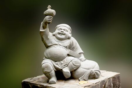 a chinese god statue set in a park in Taipeiの写真素材