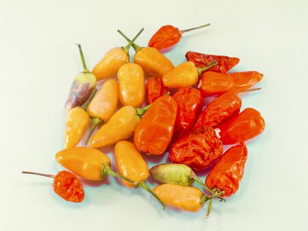 many chile peppers stacks together on white backgroundの写真素材