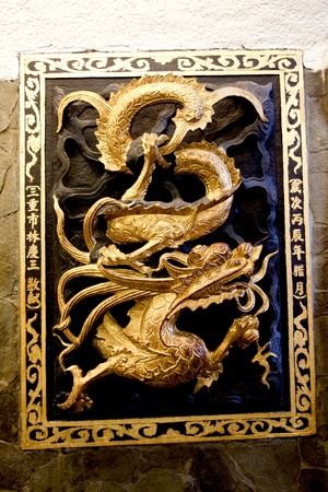 a statue of a golden gradon in a temple on wallのeditorial素材