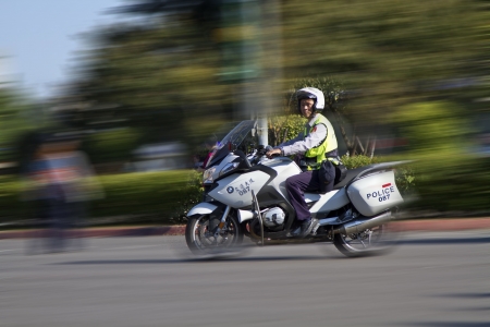 TAIPEI,TAIWAN -October 20,2012:Unidentified policeman of Taiwan riding motorcycle - doing the traffic control for street parade of "celebrating Mardi Gras of Christian" on October 20,2012 in Taipei,Taiwan .のeditorial素材