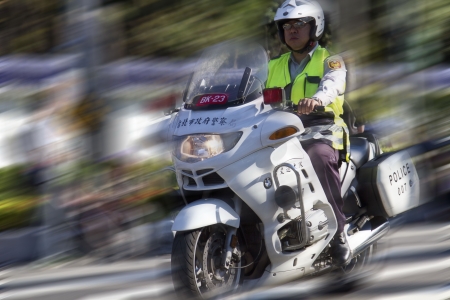 TAIPEI,TAIWAN -October 20,2012:Unidentified policeman of Taiwan riding motorcycle - doing the...