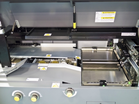 Closeup of printing machine working part with white lightの写真素材