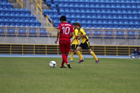 TAIPEI,TAIWAN -November 14,2012:football players in the All-Taiwan Intercity Football Competition in Taipei stadium on November 14,2012 in Taipei,Taiwanのeditorial素材