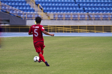 TAIPEI,TAIWAN -November 14,2012:football player in the All-Taiwan Intercity Football Competition in Taipei stadium on November 14,2012 in Taipei,Taiwanのeditorial素材