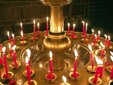 Group of burning religious candles on candlestick in bao an templeの写真素材