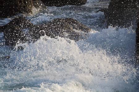 scenic of splashing waves and rocksの写真素材