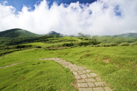 green mountain with blue cloudy sky located in summer Taipeiの写真素材