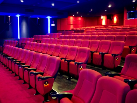 Red seats of cinema hall after the movieの写真素材