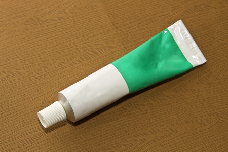 tube isolated on wooden backgroundの写真素材