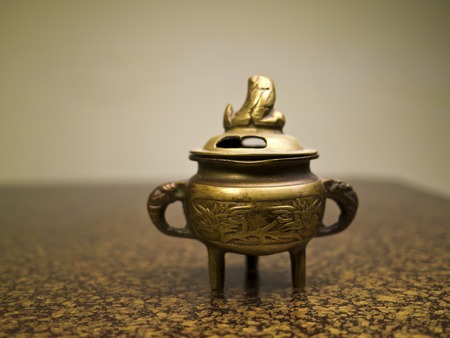 Antique incense burner on wooden table (Still life)の写真素材