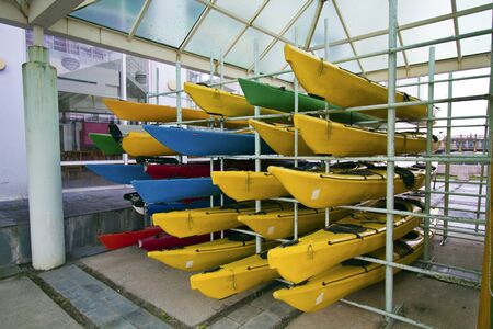 array of colorful canoes on frameworkの写真素材