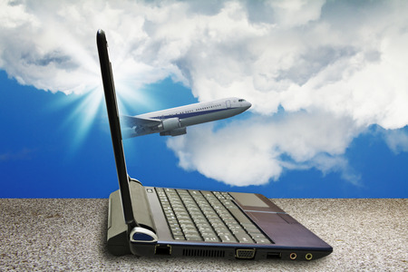 airplane through laptop,buy a travel with internetの写真素材