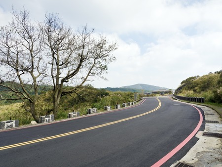 bald tree on winter raod in Yangming mountainの写真素材