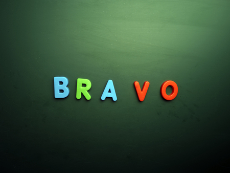 bravo concept in colorful letters isolated on blank blackboardの写真素材