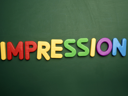 impression concept in colorful letters isolated on blank blackboardの写真素材