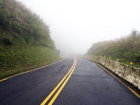 Road in national yangming mountain park in fog weather,Taipei,Taiwanの写真素材