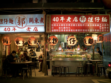 Taipei, Taiwan - Dec 17, 2015: view of people eating in restaurant at Liaoning Street night market...
