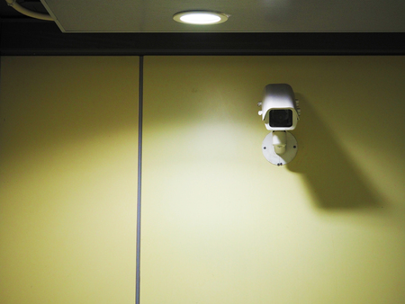 security camera in metro station on wallの写真素材