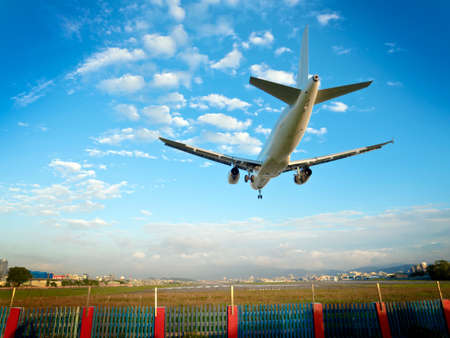 airplane landing at Taipei Songshan airport,Taipei against blue sky,Taiwan,business travelの写真素材