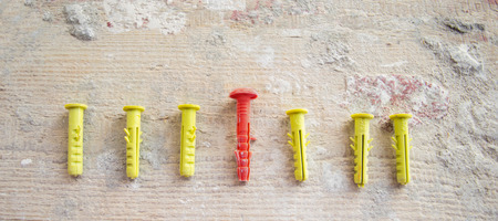 Set, pile of dowels of different colours on boards with cementの写真素材