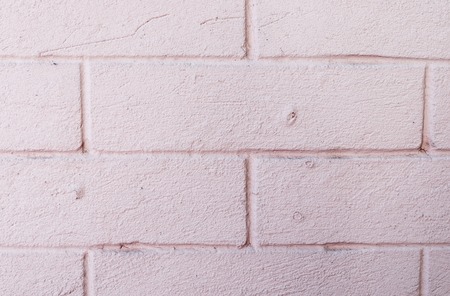 Background like a gray white pink decorative plaster, bricks