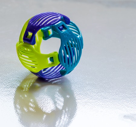 Yellow and blue ball - a children's toy, construction, model building on the floorの写真素材