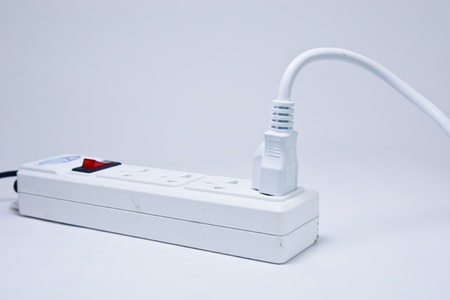 Many plugs plugged into electric power bar
