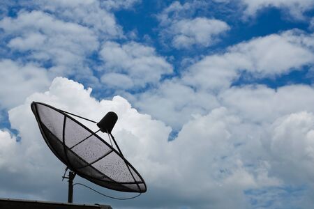 Satellite dish in blue sky の写真素材