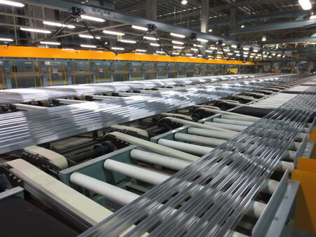 Aluminum lines on a conveyor belt in a factory.のeditorial素材