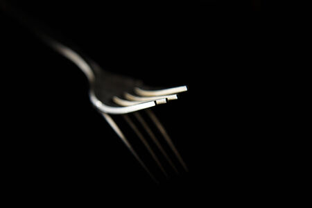fork isolated on a black backgroundの写真素材