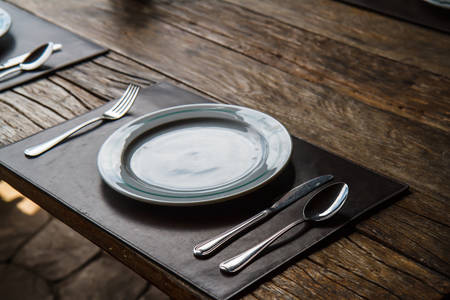 Plate fork spoon on the tableの写真素材