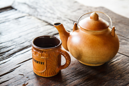 Tea Kettle on wood tableの写真素材