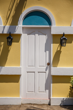 wood door on yellow wallの写真素材