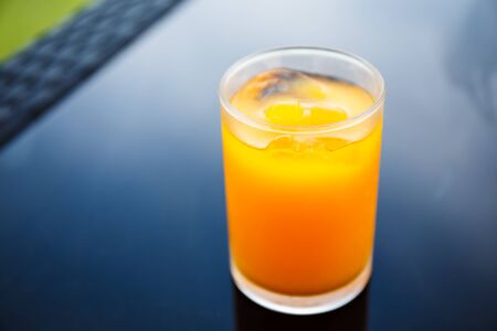 Orange juice in a glass on the tableの写真素材