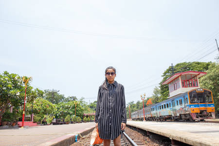 Asian young beautiful girl walking on the railwayの写真素材