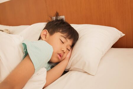 Asian boy asleep on the bed.の写真素材
