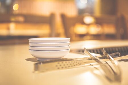 Empty white bowl with iron on the table.の写真素材