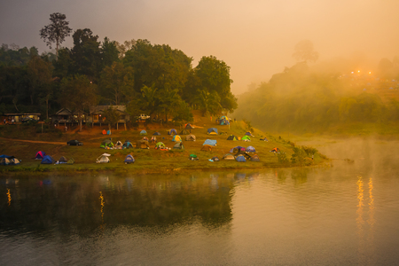 view point of  clouds and tents on a hills at sunriseの写真素材