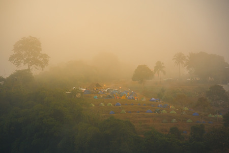view point of  clouds and tents on a hills at sunriseの写真素材