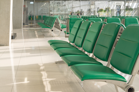 Empty airport terminal waiting area with chairs in morning time. Airport interior in waiting zone.の写真素材