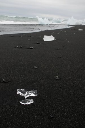 Ice cold heart - heart of ice on the black diamond beach in iceland, eruope. A heart that melts away - even on valentine's dayの写真素材