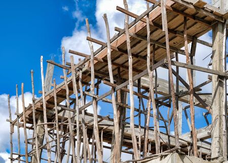 Home under construction with wood scaffolding
