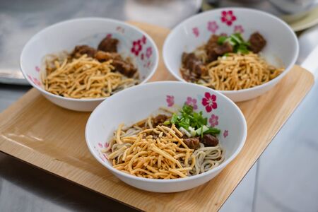 3 bowls of Khao Soi which Northern Thai Style Curried Noodle Soup with Chicken, Thai foodの写真素材